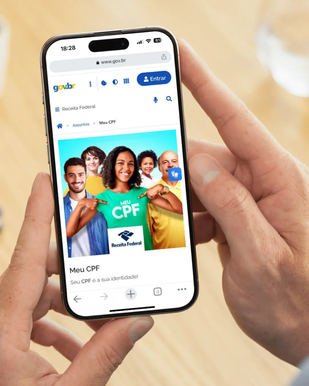 Pessoa segurando celular com página da Receita Federal aberta mostrando serviço Meu CPF.