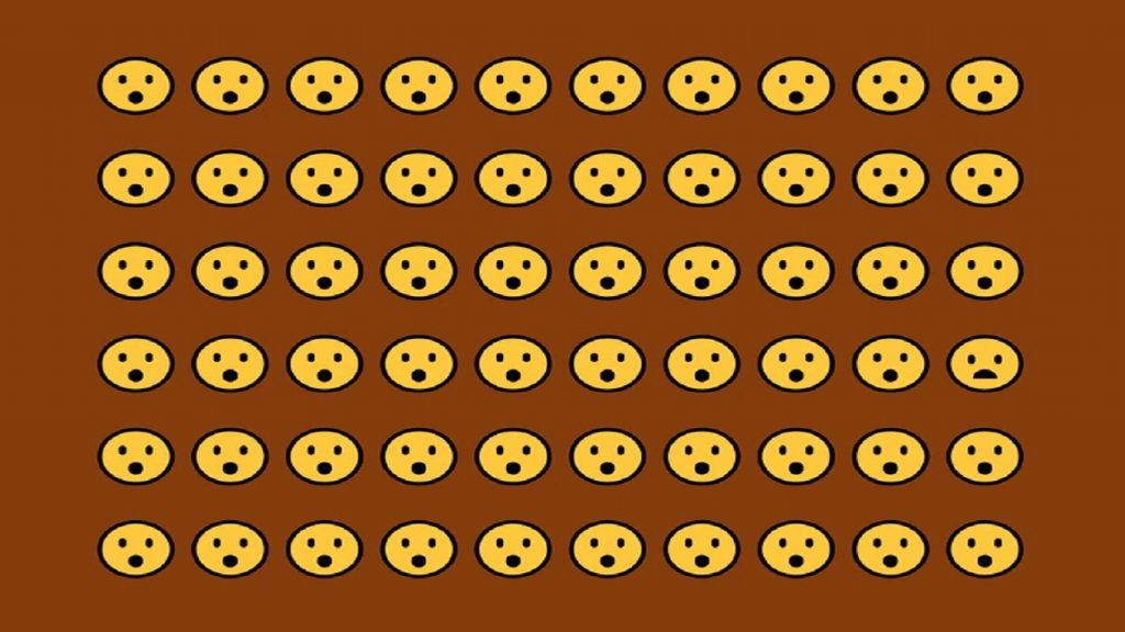 Desafio visual com uma grade de emojis com expressões surpresas, destacando um rosto triste no canto inferior direito.