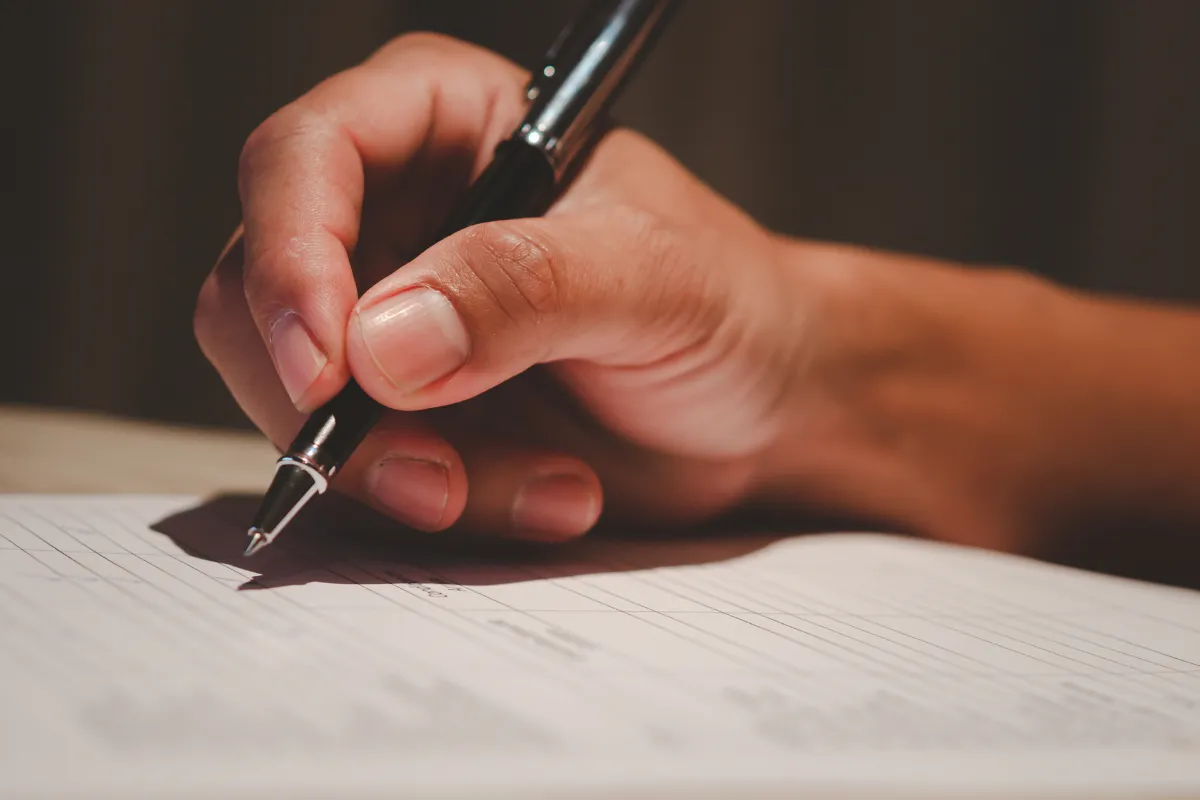 Pessoa preenchendo formulário de inscrição de processo seletivo.
