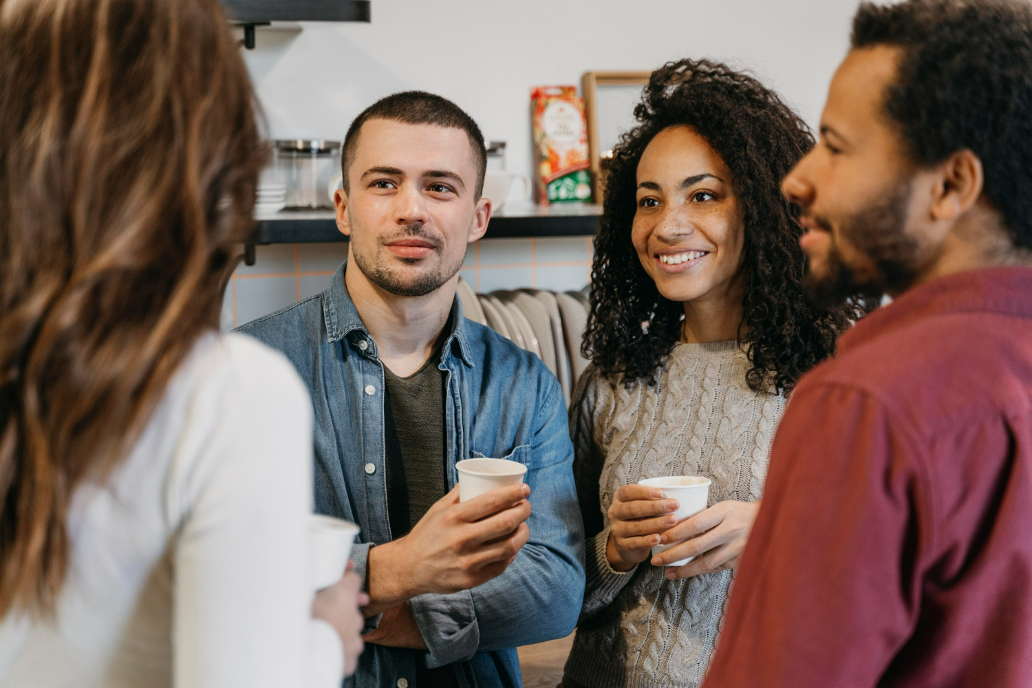 Grupo de amigos sorrindo e se socializando, discutindo sobre frases de gentileza.