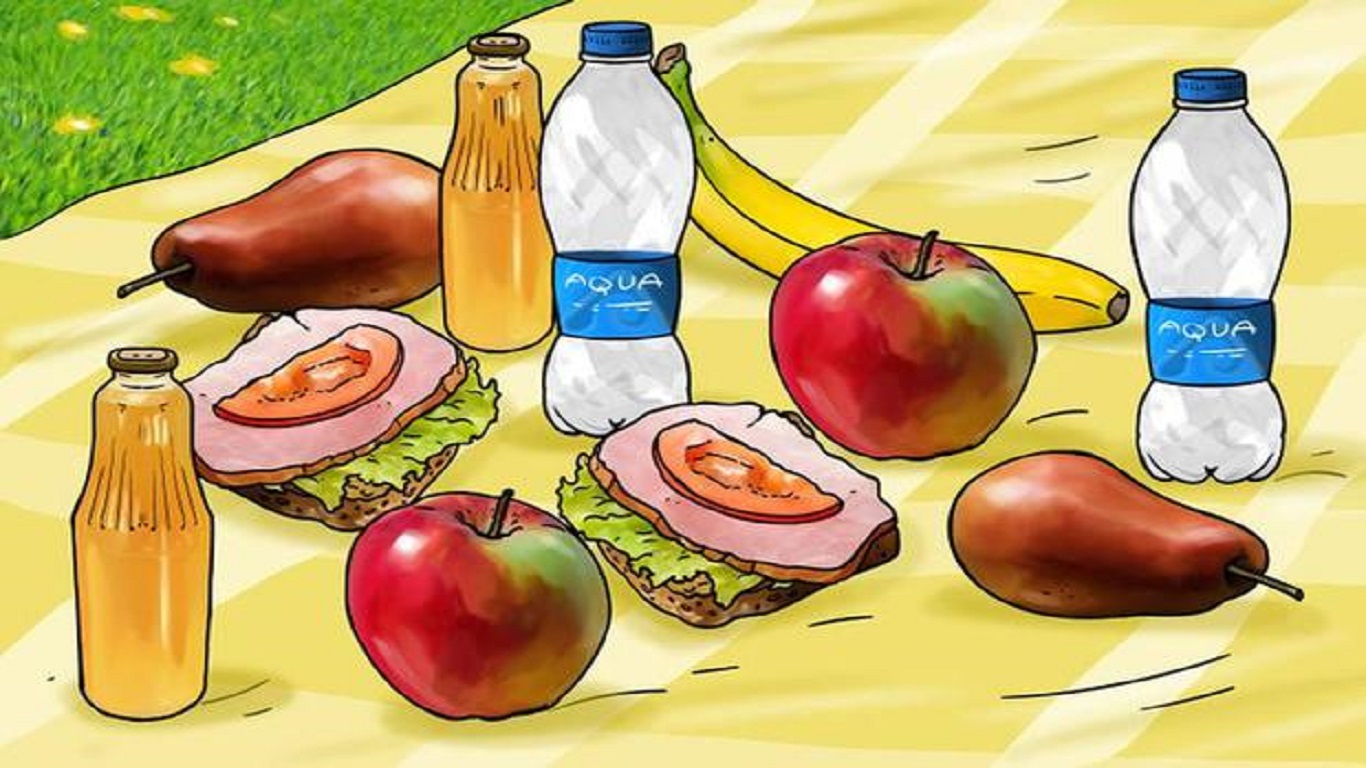 Teste visual com uma toalha amarela com sanduíches, frutas (maçã, pêra, banana) e garrafas de água e suco, como parte de um piquenique.