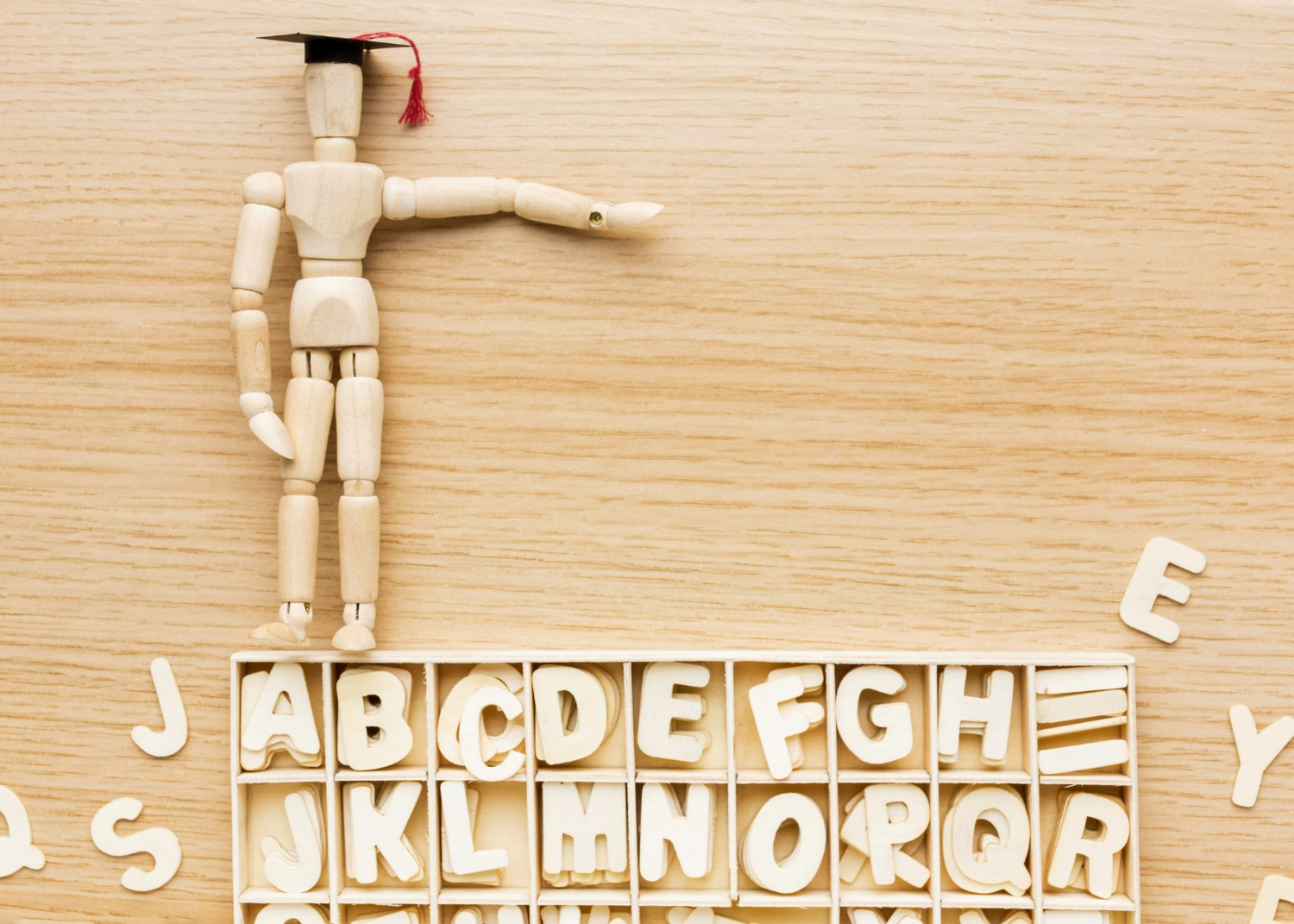Figura de um boneco com capelo apontando para uma caixa de letras, representando o processo de formalização de palavras no vocabulário oficial.