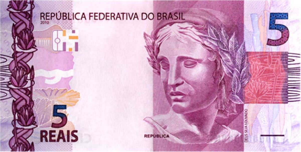 Imagem da cédula de 5 reais do Brasil, com a figura da República e elementos de segurança visíveis.