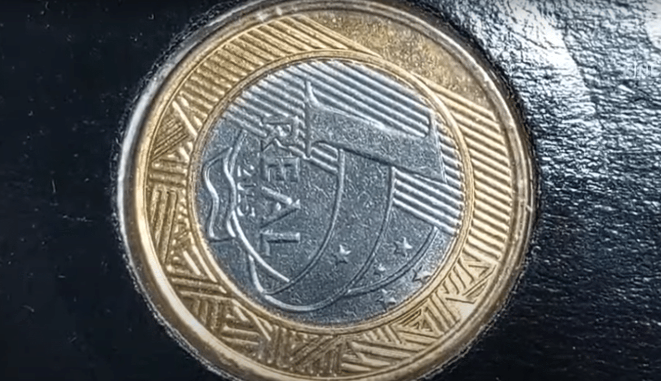 Moeda de 1 real com erro de reverso horizontal visível na imagem