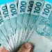 Notas de R$ 100 em dinheiro representando o Saque Calamidade do FGTS de até R$ 6.220 para trabalhadores elegíveis