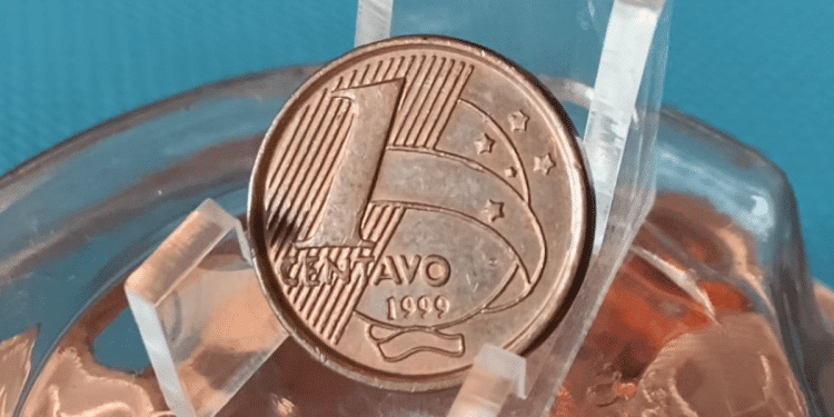 Moeda rara de 1 centavo em primeiro plano, exibindo a data de cunhagem, que pode valer até R$ 1.000 para colecionadores devido a um detalhe de erro de fabricação ou cunhagem reversa.