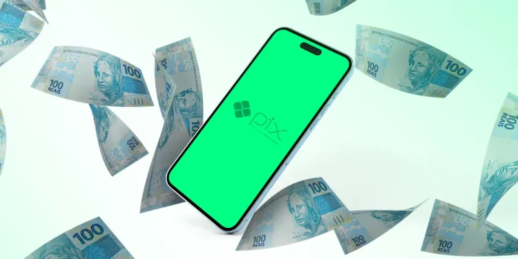 Celular exibindo logo do Pix com cédulas de 100 reais brasileiras ao redor em fundo branco