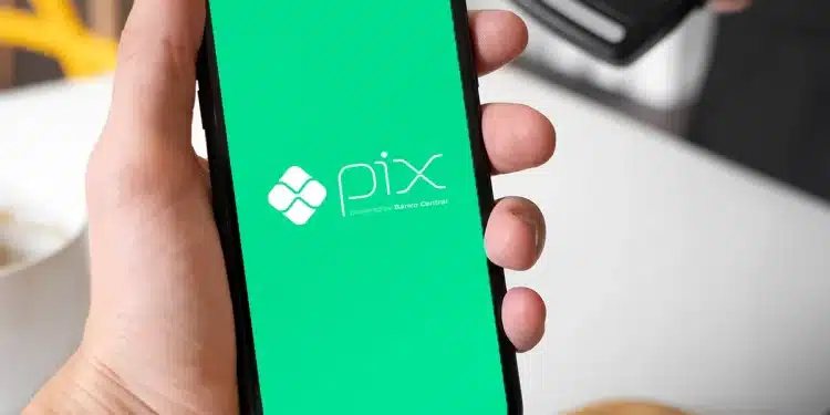 Imagem de um smartphone exibindo o logo do Pix, sistema de pagamentos do Banco Central, com fundo verde, representando o novo botão de contestação para segurança nas transações.