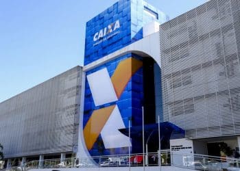 Prédio da agência Caixa Econômica Federal com fachada azul e cinza em estilo contemporâneo.