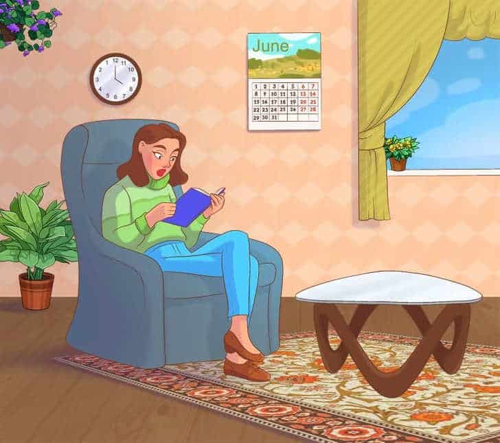 Mulher sentada em poltrona azul lendo livro com expressão surpresa em sala iluminada.