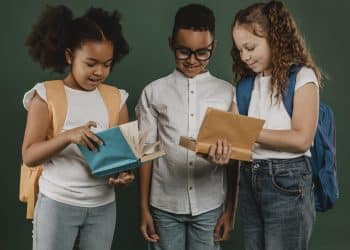 school colleagues looking through books together