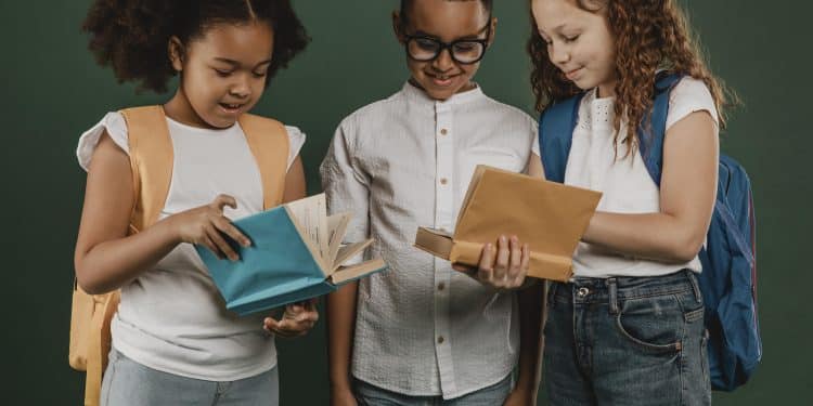school colleagues looking through books together