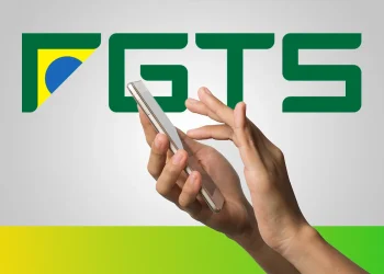 Mãos usando smartphone com logotipo do FGTS ao fundo em destaque