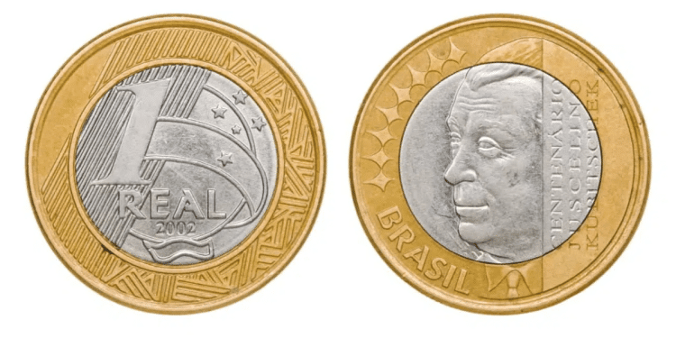 Anverso e reverso da moeda de 1 real brasileira de 2002, comemorativa do centenário de Juscelino Kubitschek, exibindo o rosto de JK e o valor nominal.