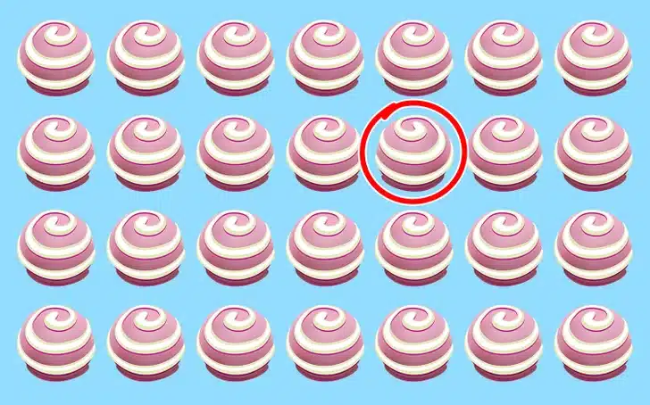 Teste visual com vinte e oito doces redondos rosa e branco em espiral sobre fundo azul