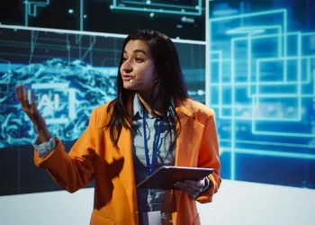 Mulher apresentando conteúdo sobre inteligência artificial em evento de tecnologia e inovação.