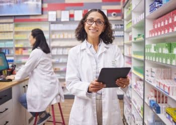 Farmacêutica utilizando tecnologia para gestão de medicamentos, destacando inovação no setor de Farmácia.