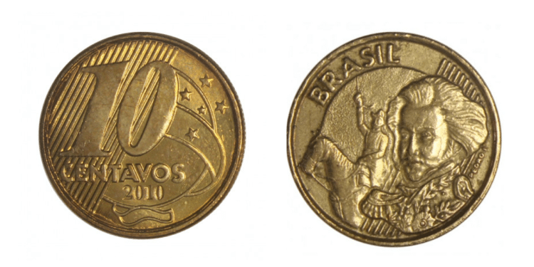 Fotografia das duas faces de uma moeda de 10 centavos de Real dourada, ano 2010. À esquerda, o reverso com o valor "10" e estrelas. À direita, o anverso com a efígie de Dom Pedro I e a palavra "Brasil".