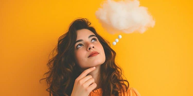 Mulher olhando para cima com balão de pensamento ilustrando a mente criando cenários imaginários ligados à ansiedade.