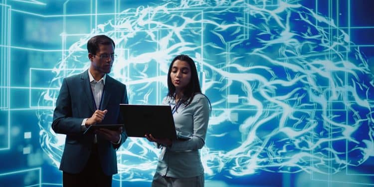 Profissionais analisando dados em notebook diante de representação visual de inteligência artificial e redes neurais digitais