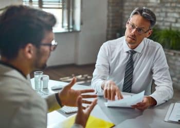 Entrevistador e candidato em uma conversa durante uma entrevista de emprego no escritório.