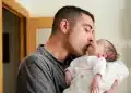 Pai segurando e beijando um recém-nascido, representando o fortalecimento do vínculo familiar após aprovação do Senado para ampliar gradualmente a licença paternidade no Brasil.