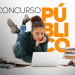 Jovem de cabelos cacheados usa notebook deitada no chão cercada de livros com texto “CONCURSO PÚBLICO” ao fundo