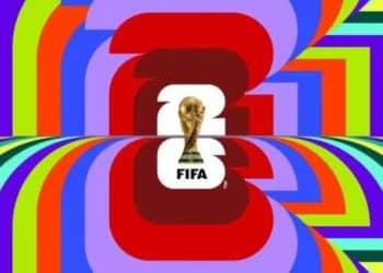 Logotipo oficial da Copa do Mundo FIFA 2026 centralizado, com o troféu dourado sobre o número 26, cercado por um fundo psicodélico de linhas curvas multicoloridas em tons de azul, verde, vermelho e amarelo.