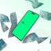 Celular com símbolo do Pix cercado por notas de dinheiro, simbolizando o pagamento de R$ 200 do Pé-de-Meia.
