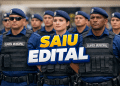 Agentes da Guarda Municipal em formação com coletes balísticos e boinas azuis, texto "Saiu Edital" em destaque