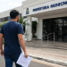 Candidato com documento de processo seletivo em frente à Prefeitura Municipal.
