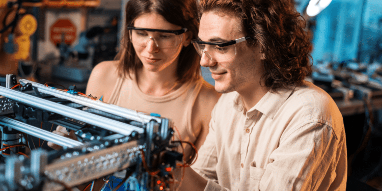 Jovens desenvolvendo projeto de robótica em laboratório moderno.