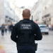 Policial civil patrulha rua movimentada em operação urbana.