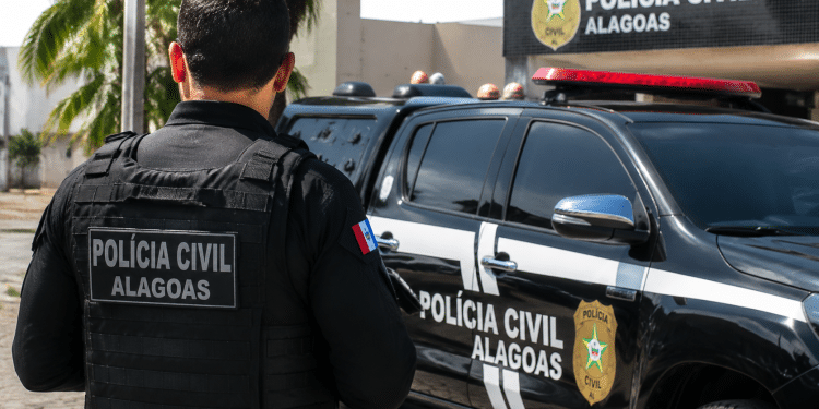 Policial da Polícia Civil de Alagoas ao lado de viatura oficial, ilustrando concurso com banca Cebraspe definida.