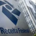 Placa da Receita Federal em frente a prédio institucional, relacionada a novidades anunciadas para julho.